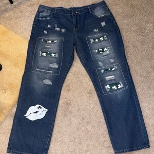 Size18 womans Jeans embellished with white 4 leaf clovers on a green background